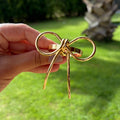 Porta-guardanapo laço dourado